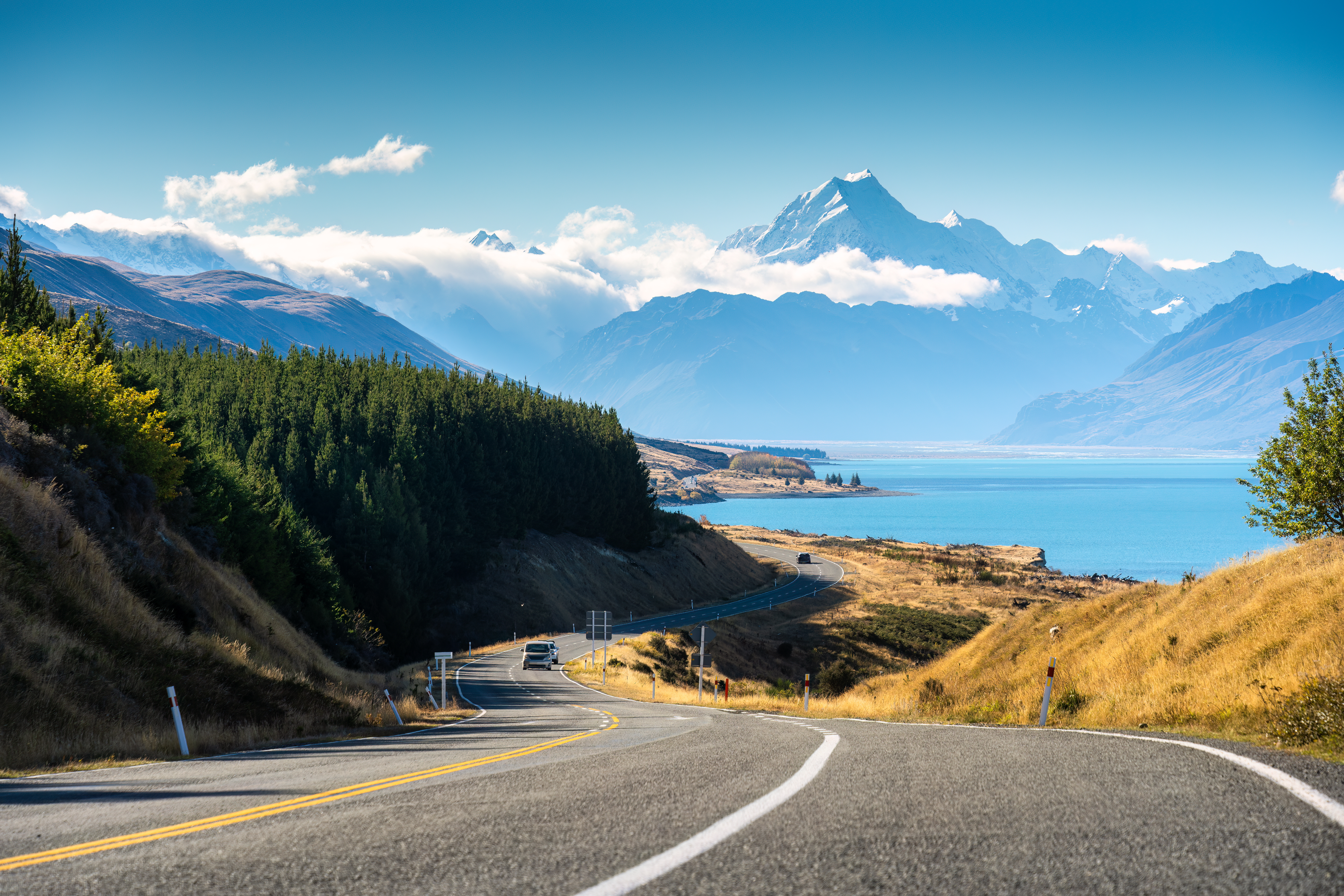 Mountain road winding through snow-capped alpine peaks